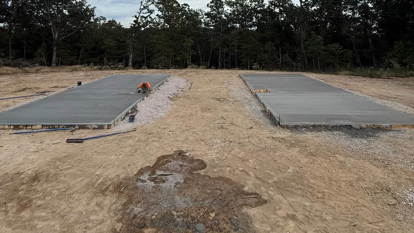 After: two finished concrete slabs on the cleared lot