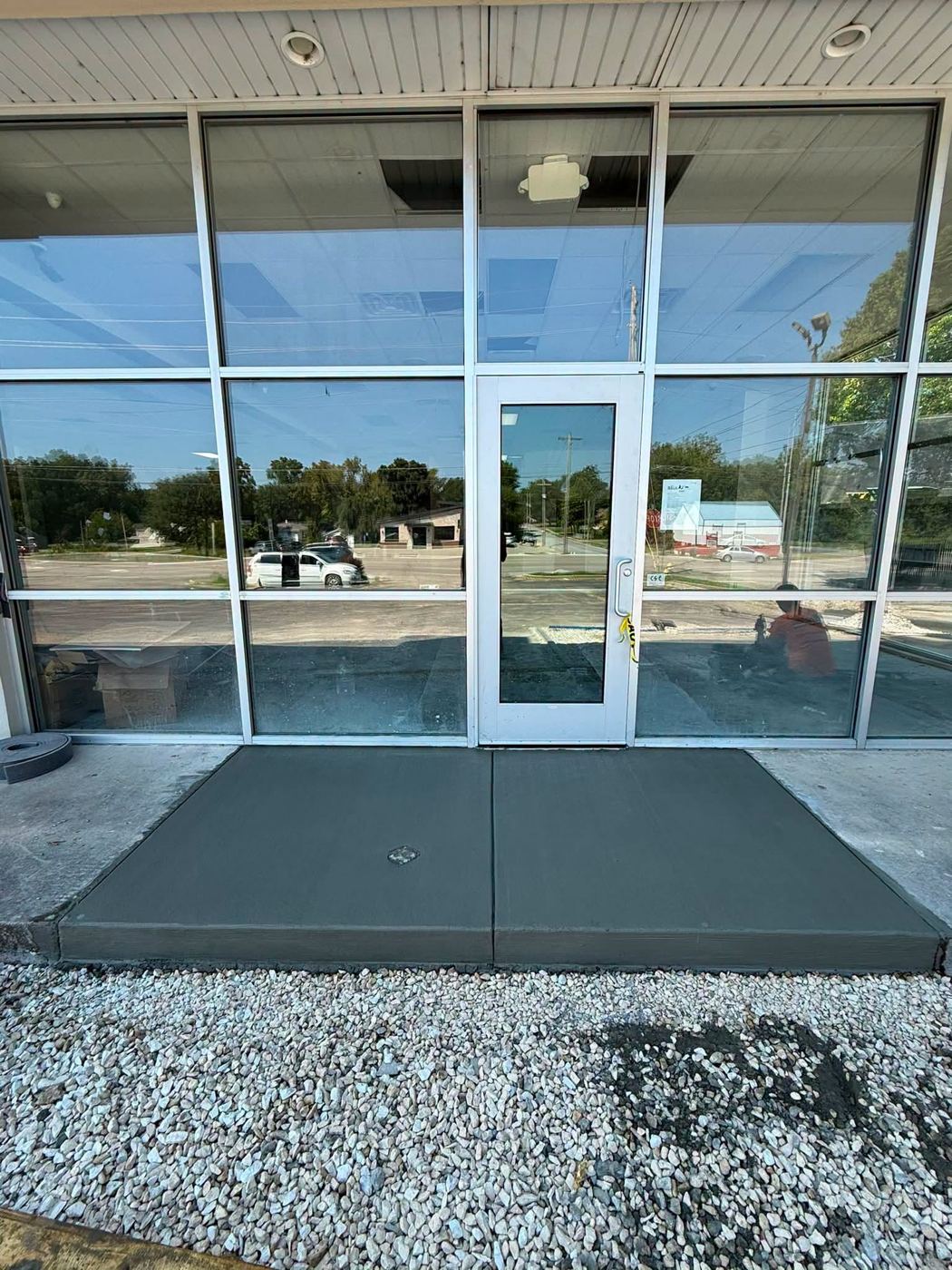 New concrete entry pad in front of a storefront