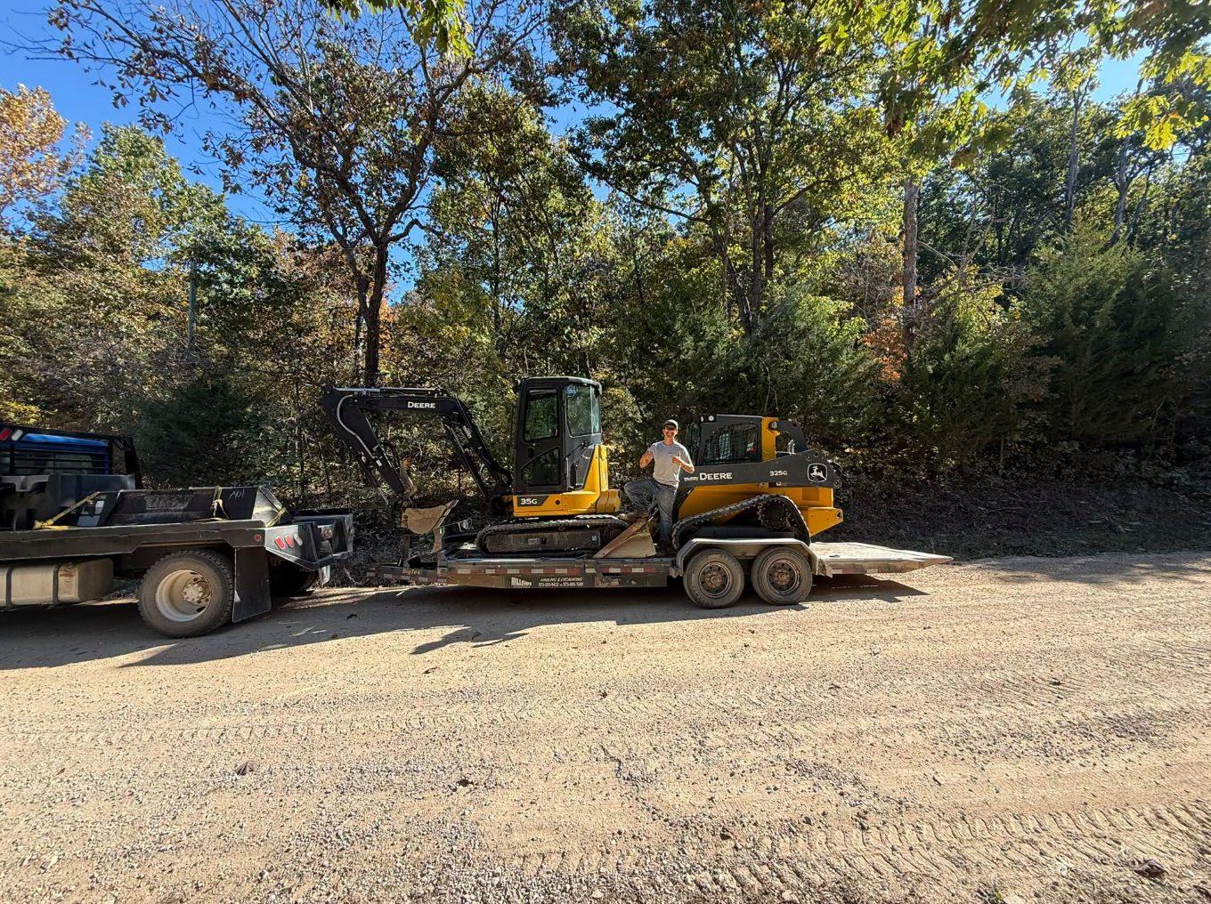 John Deere mini excavator and track loader loaded on a trailer