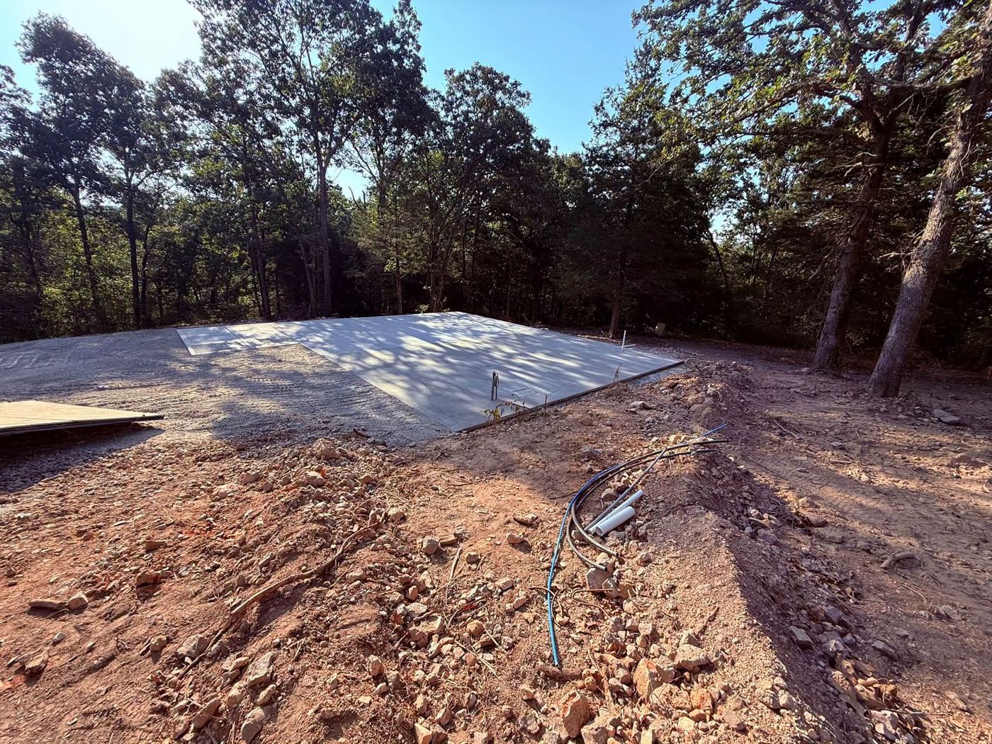 Large concrete slab in a cleared wooded lot
